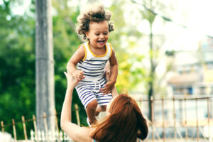 woman lifting child